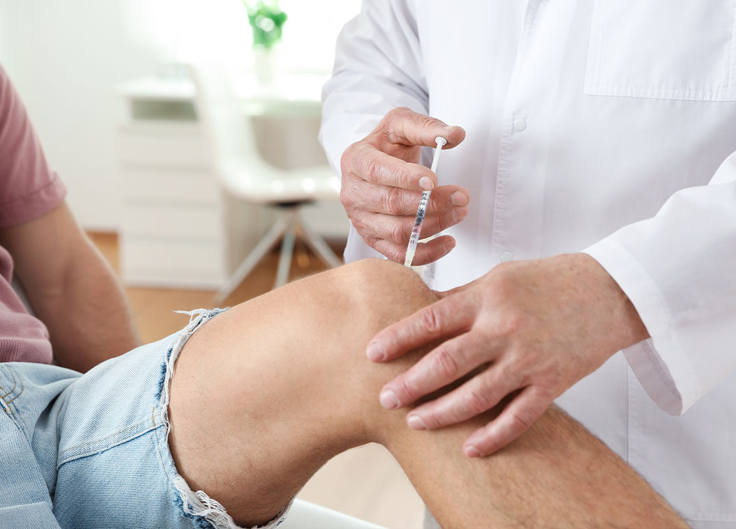 Doctor performing Advanced Joint Pain Relief injection on patient suffering with joint pain
